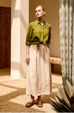 Woman wearing a premium pure linen tee styled with a skirt