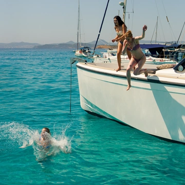 Boat at sea in Ibiza with 3 people wearing Lands' End clothing