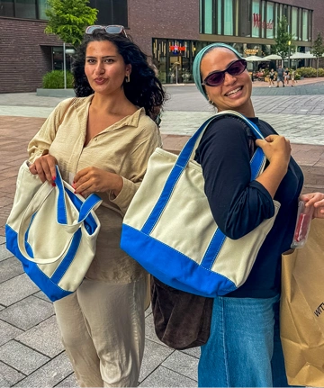 Group of people wearing summer outfits and Lands' End tote bags while enjoying an ice cream Lands' End branded