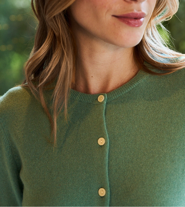  Woman wearing a green cashmere cardigan