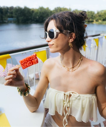 Woman eating an ice cream with a Lands' End logo.