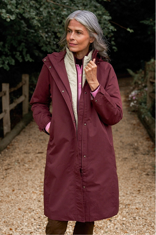 Woman wearing a burgundy 4-in-1 Coat outdoors